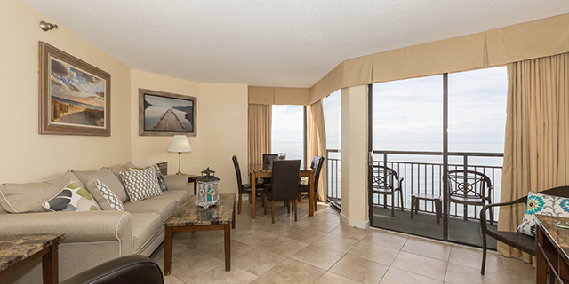 Featuring 2 queen beds, 1 bathroom, sitting area, fully-equipped kitchen, and private balcony with an oceanfront view.