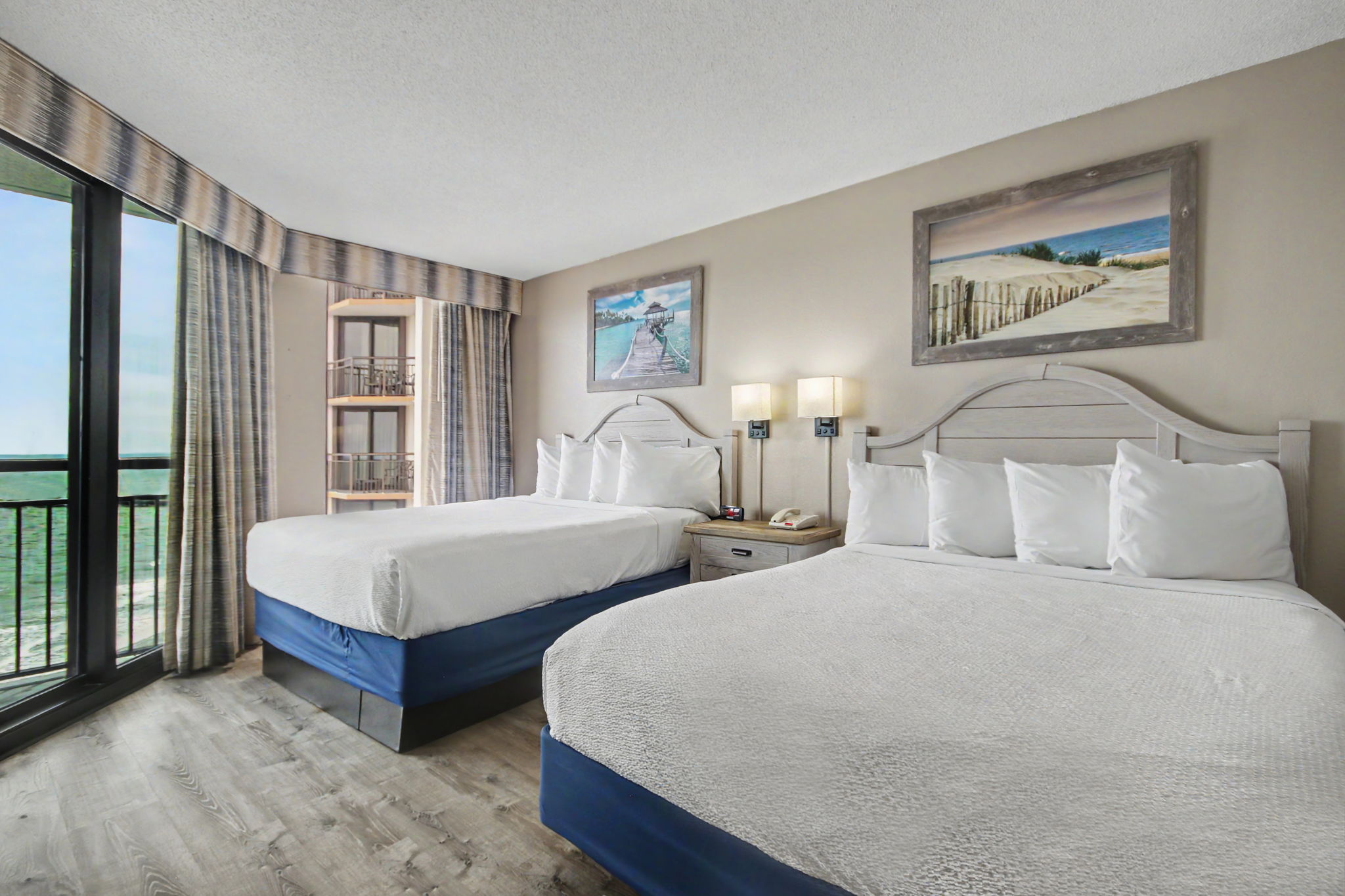 Oceanfront 1 Bedroom Suite offers guests a cozy stay with two Queen Size beds in the bedroom, a living room with Murphy bed, a full kitchen, one bathroom, two TVs and oceanfront balcony. This unit type is not pet friendly.