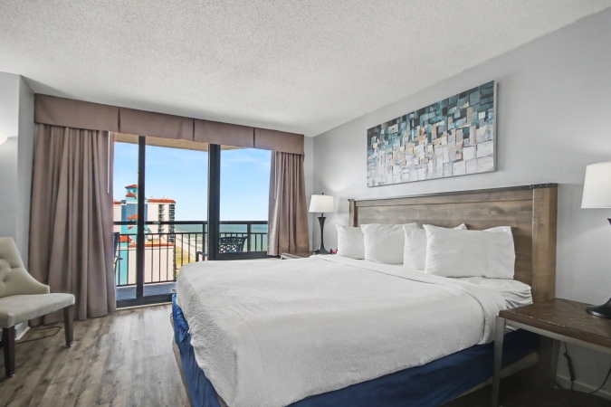 Features 1 king bed in the bedroom, a living room with a sleeper sofa, a full kitchen, 1 bathroom, two TVs and a private balcony with an ocean view. This suite is not pet-friendly.